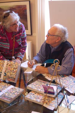 Andrew Kusmin signs a copy of his book, Palette of Dreams